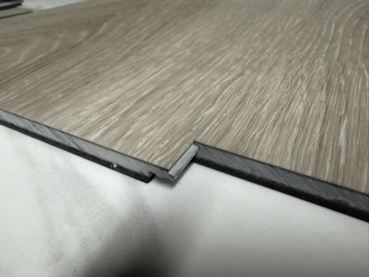 Side profile view of SPC flooring showing core density and click profile