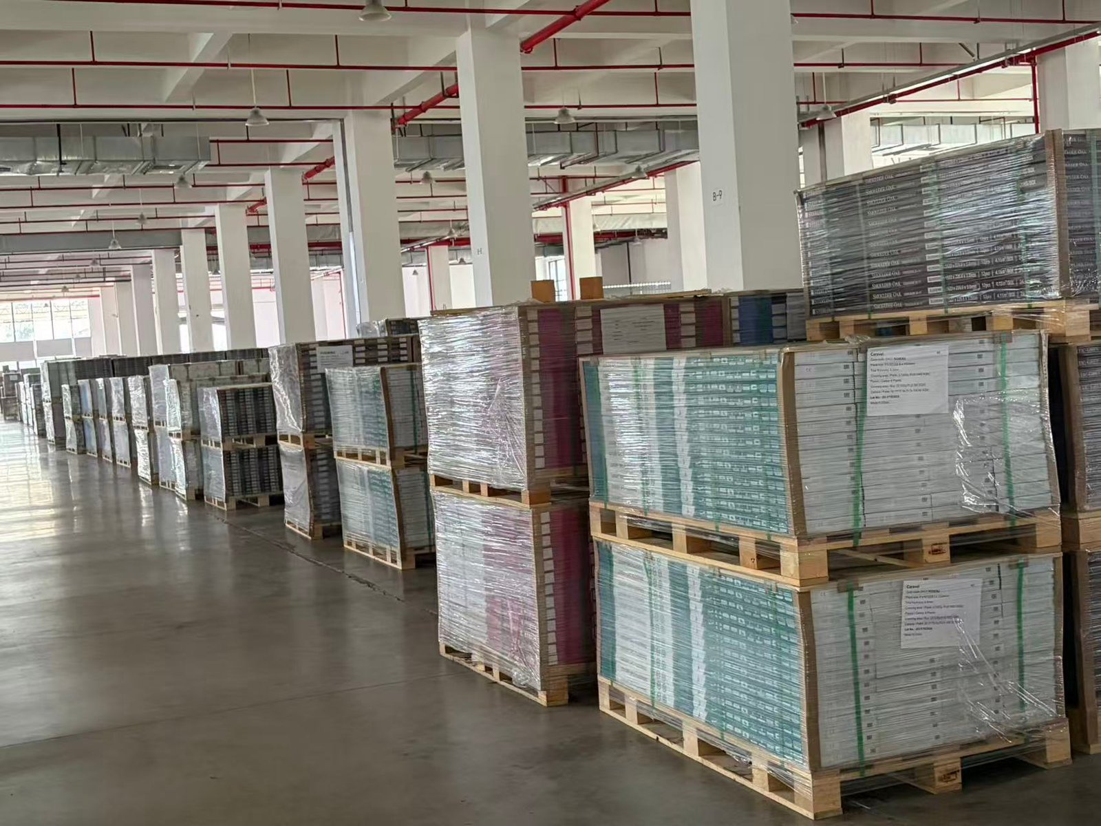 Palletized SPC flooring cartons stored in the finished-goods warehouse